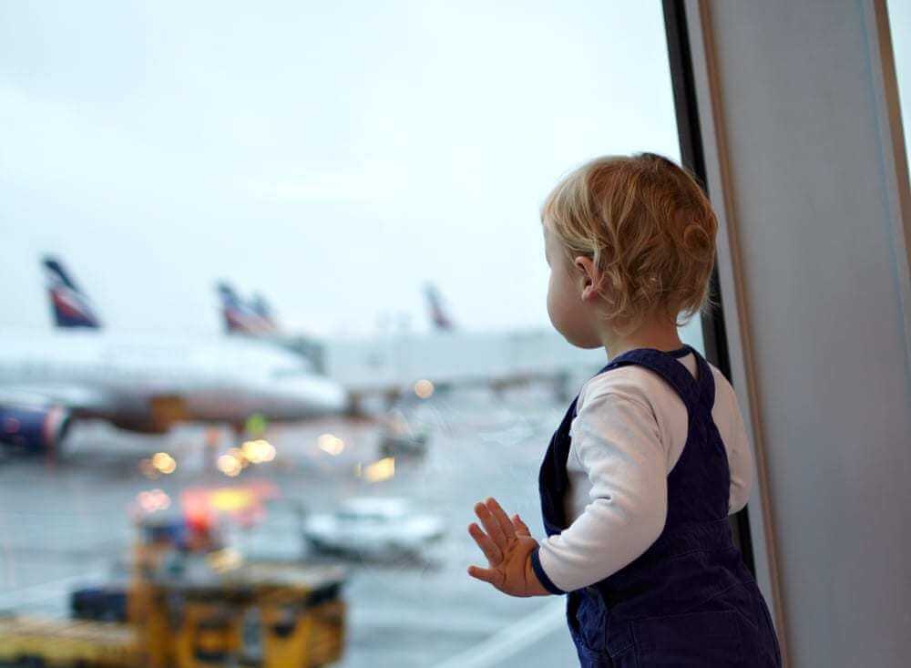 Baby near a window in an airport